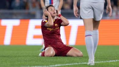 A Valiant Effort from a football player sitting on the ground after a match between Roma and Barcelona.